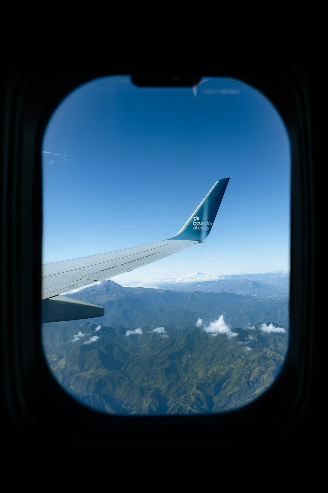 a-view-of-the-wing-of-an-airplane-as-it-flies-over-a-mountain-range-luakpwatkug